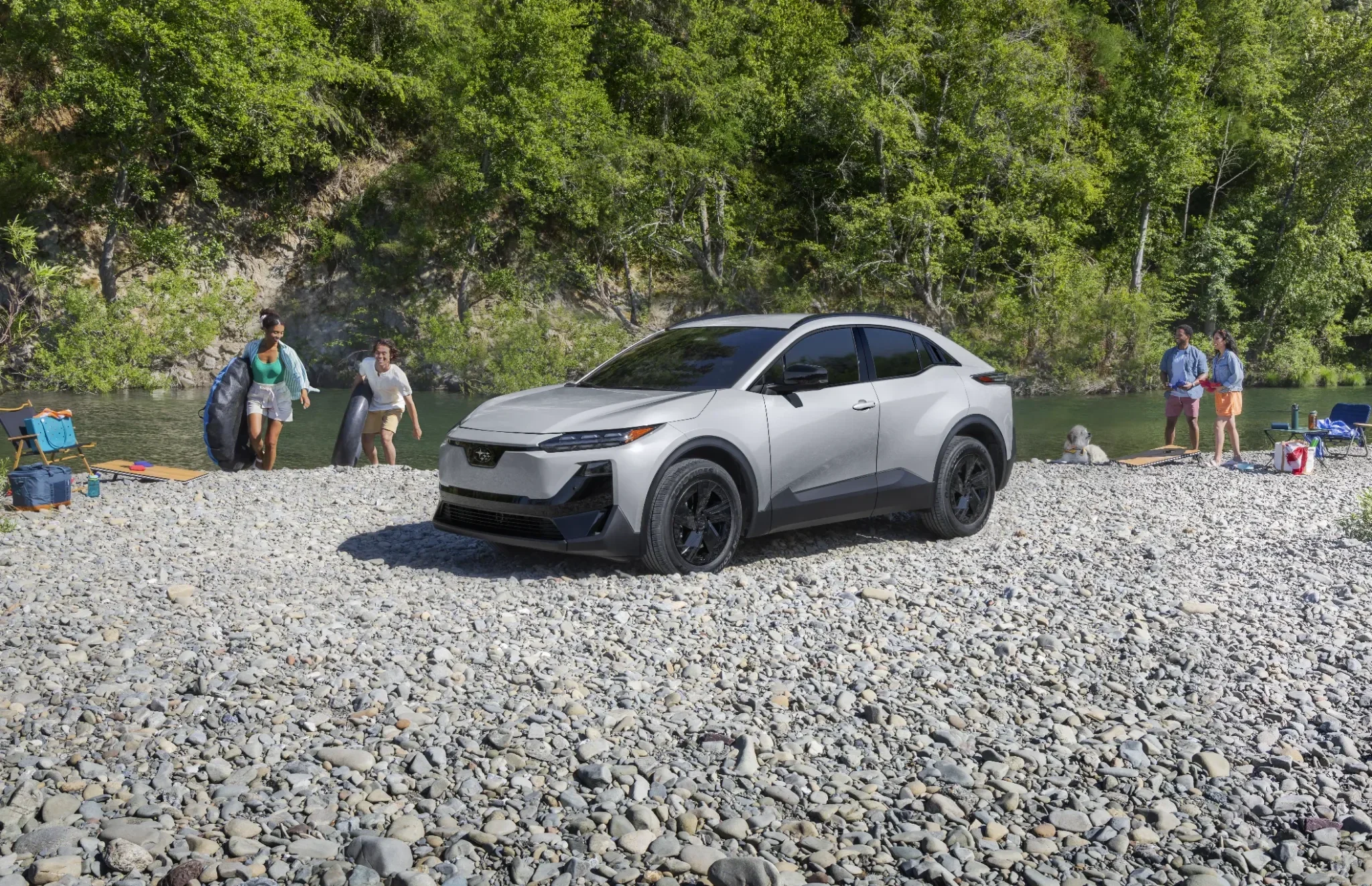 A static image of Uncharted Sport in Metropolis Gray Metallic parked on a rocky bank of a river. 