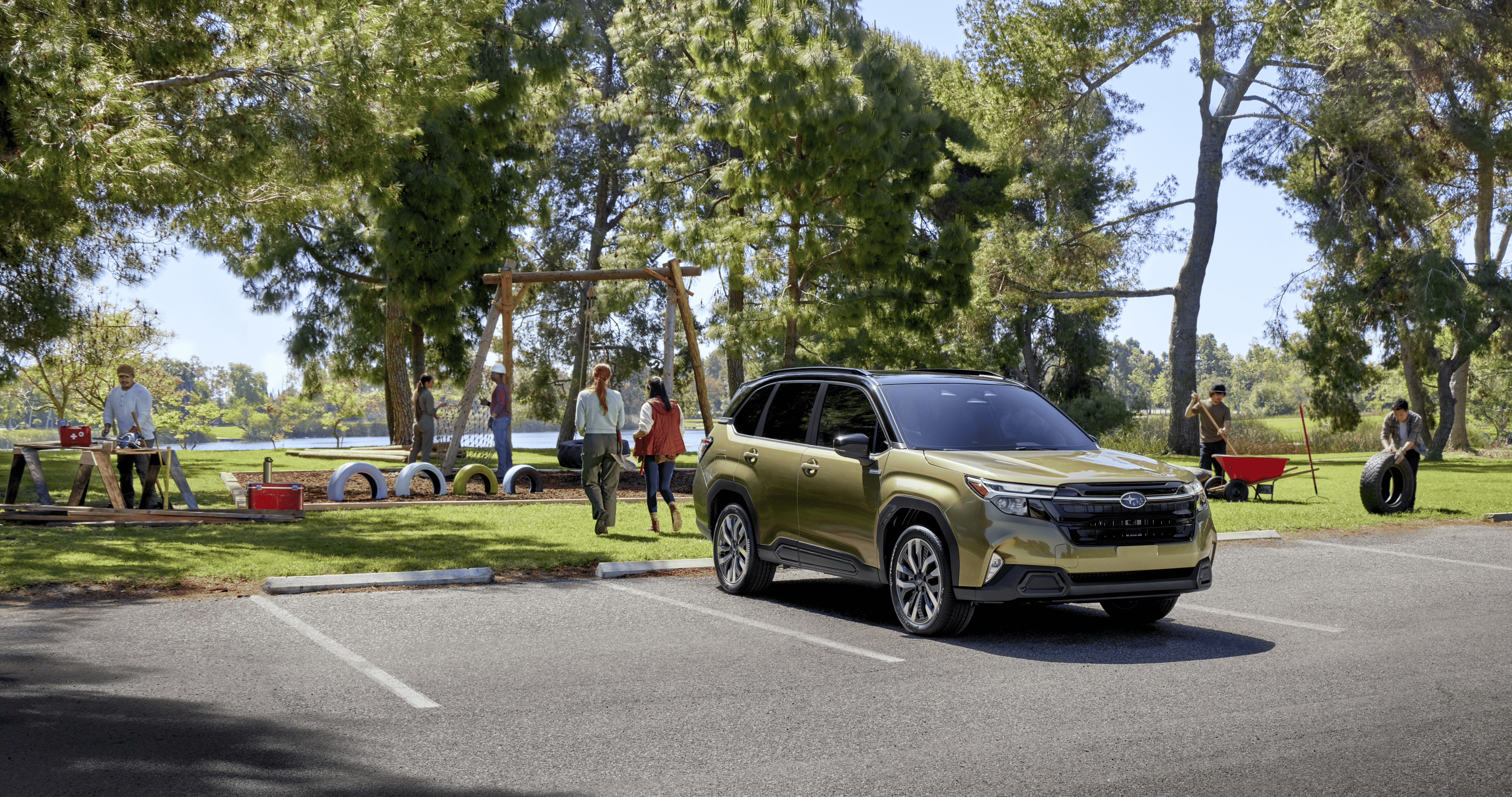 A Subaru Forester Hybrid parked in a sunny park lot near a playground.