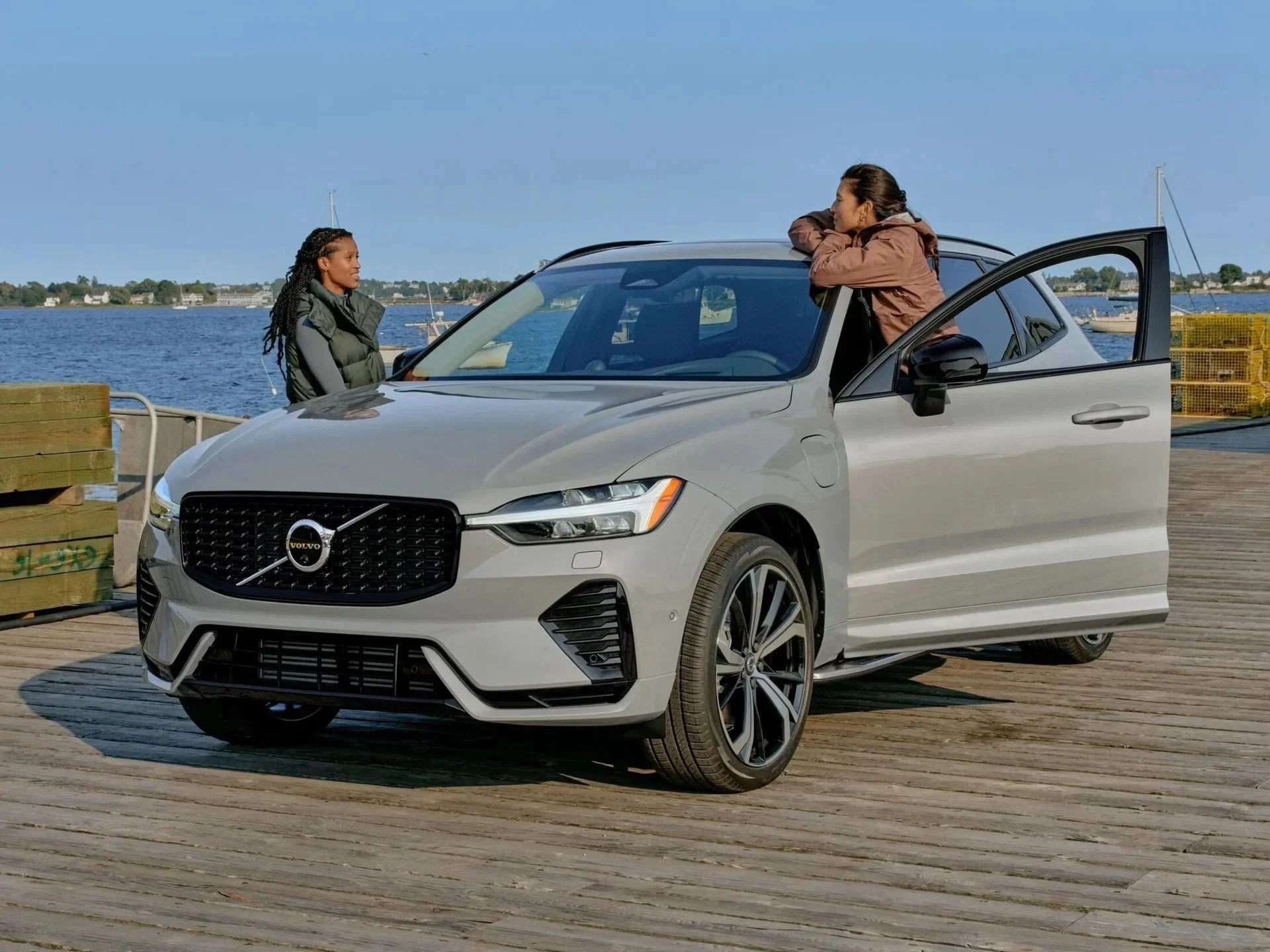 Two people standing near Volvo XC60 on pier 