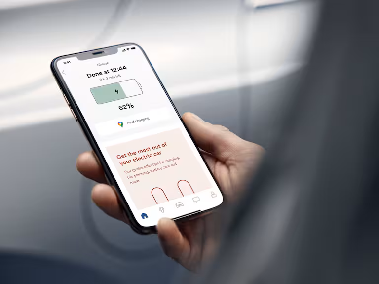 Close-up of a smartphone screen showing a Volvo driver the charging status of their car as it appears in the Volvo Cars app.